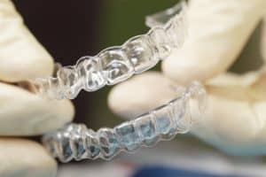 Dentist holding Invisalign dental braces 